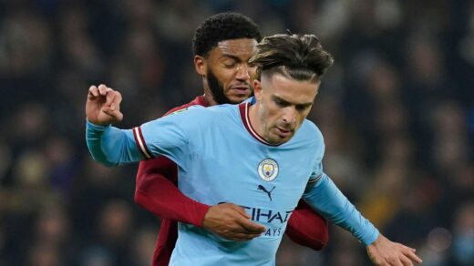 Liverpool defender Joe Gomez tries to tackle Manchester City forward Jack Grealish